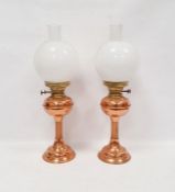 Pair of copper and brass oil lamps, marked Duplex made in England, with their accompanying chimney