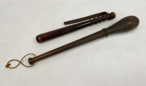 Carved wooden truncheon and another, 50cm and 39cm (2)