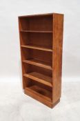 Early 20th century oak bookcase, the five shelves raised on plinth base, 133cm x 67cm x 23cm