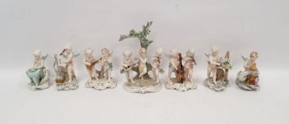 Seven early 20th century Italian Capodimonte porcelain figures of putti at various pursuits, painted