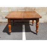 Victorian mahogany extending dining table, the rectangular top with rounded front corners, two