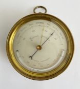 Late 19th century brass cased aneroid barometer, the silvered dial with thermometer, 12cm diam,