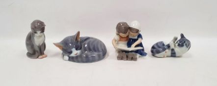 Three 20th century Royal Copenhagen models of cats and a figure group, printed green marks, blue