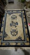 Three Chinese cream ground rugs, two 182cm x 124cm and one 273cm x 184cm