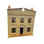 Cream two story doll's house with a large collection of dolls, dolls house furniture to include
