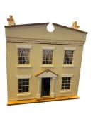 Cream two story doll's house with a large collection of dolls, dolls house furniture to include