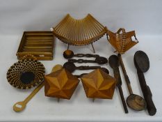 Two treen bowls of octagonal form on three tapering triangular legs, two folding baskets, assorted