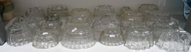 Collection of twenty-one glass press-moulded jelly moulds, in various designs including a rabbit,