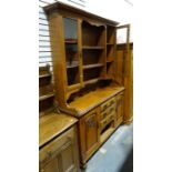 Arts & Crafts-style oak dresser, the ogee moulded cornice above assorted shelves and two glazed