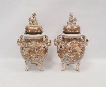 Pair of Japanese Satsuma vases and domed covers, early 20th century, painted in gilt with flowers