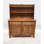 Mid-coloured Ercol dresser, the waterfall top with two plateracks, on a base of two drawers and