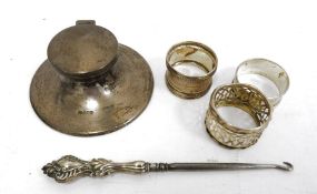 Silver capstan inkwell of typical form, Sheffield assay, three various napkin rings and a silver-