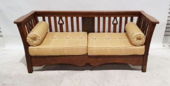 Arts & Crafts oak three-piece suite comprising twin-seat settee and pair of armchairs, the settee of