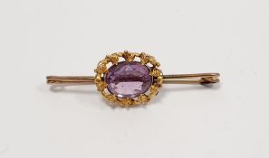 Gold coloured metal and amethyst bar brooch set single oval faceted stone