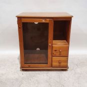 20th century pine cabinet, the rectangular top with rounded front corners, moulded edge above single