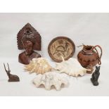 Carved figure in feathered headdress, treen bowl, Egyptian-style cat, gazelle, gourd, seashells, etc