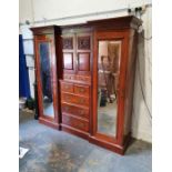 Late Victorian/early Edwardian breakfront wardrobe, the moulded cornice above centre of two cupboard