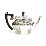 Silver teapot, oval and serpentine-shaped, Birmingham 1909, with ebonised handle, 18ozt approx.