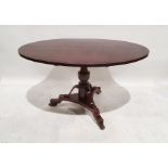Unusual Regency loo table, the oval mahogany top on turned and carved pedestal, to a triform base,