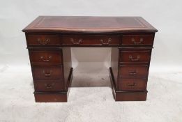 Modern mahogany and leather inset topped pedestal desk with serpentine front, nine assorted drawers,