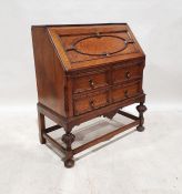 Early 20th century oak bureau with moulded decoration to the fall, above two short and one long