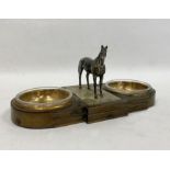 Double ashtray with glass bowls inset in metal with a silver-coloured metal model of a horse, with