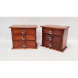 Pair of miniature chests of three long drawers, on pedestal base with replacement faceted flower-