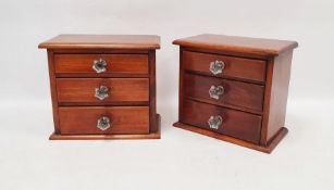 Pair of miniature chests of three long drawers, on pedestal base with replacement faceted flower-