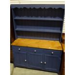 Blue-painted dresser with two shelves, a pine top above three drawers and cupboard doors