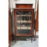 Edwardian mahogany single-door glazed cabinet with astragal-glazed door enclosing shelves, on square