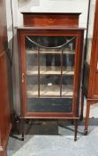 Edwardian mahogany single-door glazed cabinet with astragal-glazed door enclosing shelves, on square