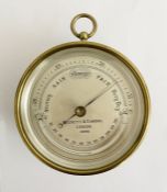 Early 20th century brass cased Negretti & Zambra (London) barometer, the silvered dial numbered