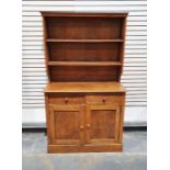 Early 20th century oak dresser, the moulded cornice above two shelves, on a base of two drawers, two