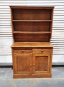 Early 20th century oak dresser, the moulded cornice above two shelves, on a base of two drawers, two