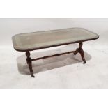 20th century mahogany and leather-topped coffee table on turned end supports to ogee legs,