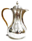 Edward VII silver hot water jug, baluster-shaped with high domed hinged lid, raffia-bound serpentine