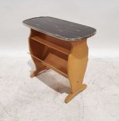 Mid-century coffee table with magazine rack under, the black glass top with gold-coloured