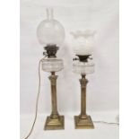 Two similar brass Corinthian column oil lamps with clear glass faceted reservoirs, converted to