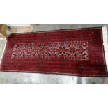 Iranian-style red ground rug with four repeating motifs to the central field, on a stepped border