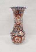 Late 19th century Imari faceted baluster vase, with tall flared neck, painted with panels of