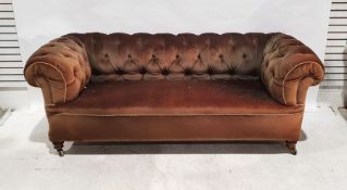 Victorian Chesterfield sofa in brown upholstery, on turned front legs to castors Condition