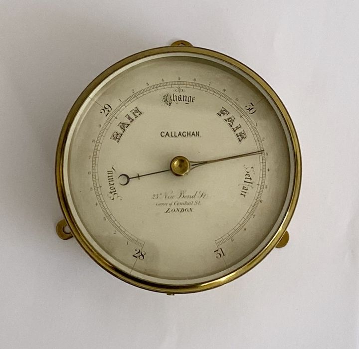 Victorian brass cased barometer produced by Callaghan of London, with silvered dial and three wall