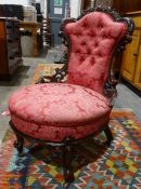 Low Victorian chair with carved and pierced mahogany frame, pink upholstered seat and back, on
