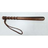 Carved wooden truncheon with wrist strap, 38cm