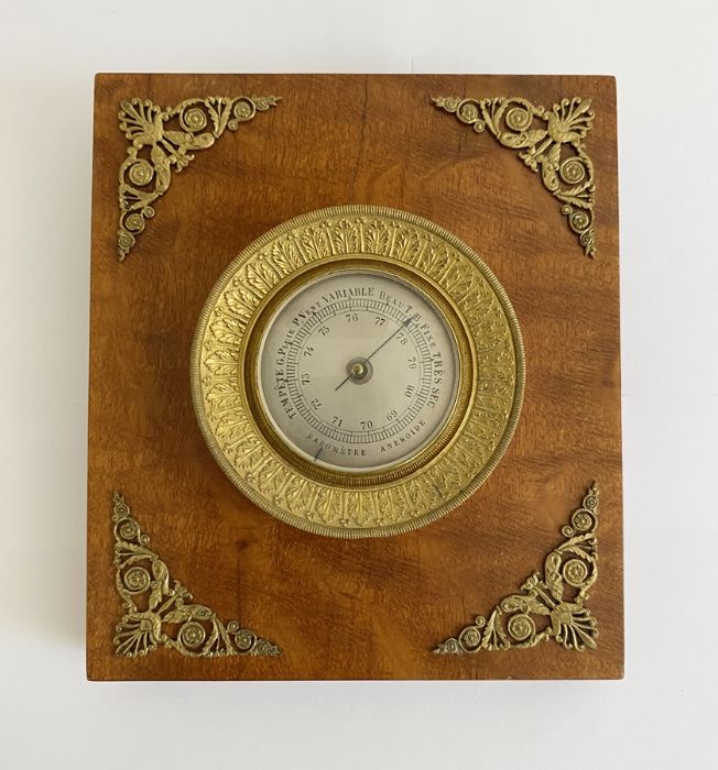 French Empire style gilt-metal and wood mounted desk barometer, aneroid with silvered dial (