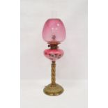 Brass oil lamp with pink glass bowl decorated with daisies, twisted column with chimney and