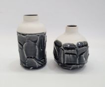 Two Studio porcelain vases with roughly faceted exterior and black glaze, indistinctly marked to