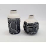 Two Studio porcelain vases with roughly faceted exterior and black glaze, indistinctly marked to