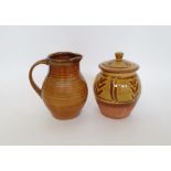 Suzy Cree (b.1952) a terracotta lidded jar with yellow slip glaze and finger swipe decoration,