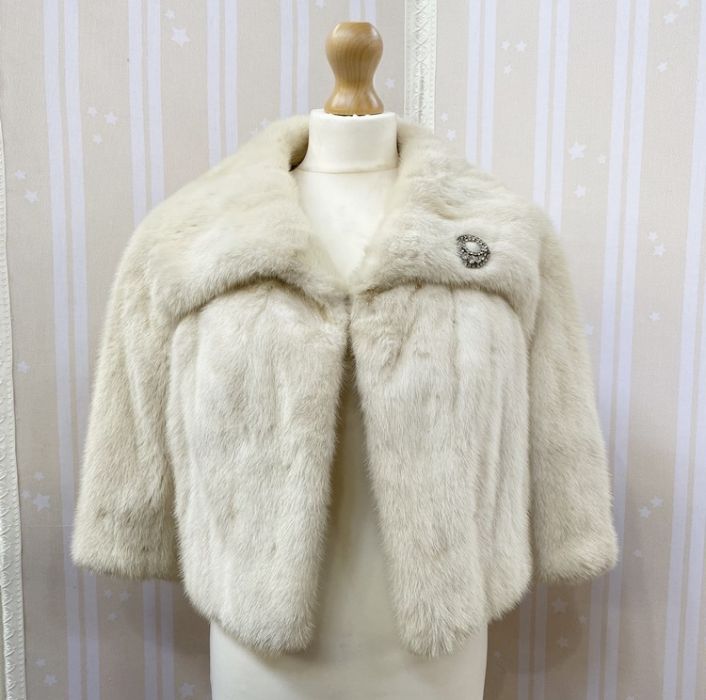 White mink short evening jacket with diamante brooch attached, three-quarter length bell sleeves